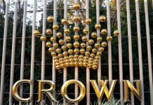 FILE PHOTO: The logo of Australia's top casino operator Crown Resorts adorns a fence surrounding the Crown Perth hotel and casino complex in Western Australia | AGB - Asia Gaming Brief