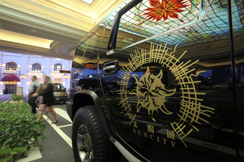 A limousine featuring the company logo of Suncity Group is parked outside Macau Galaxy resort in Macau