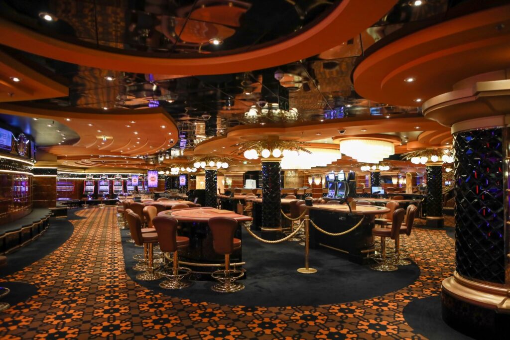 Casino floor with gaming tables and rows of slot machines