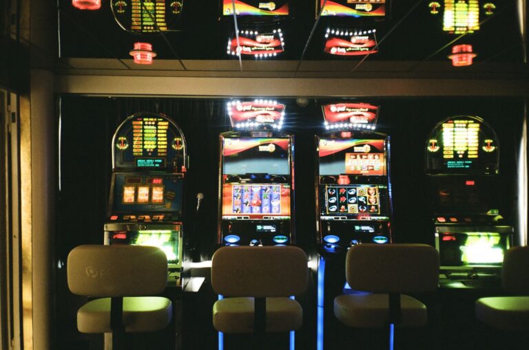 Row of electronic gaming machines in a dimly lit gaming venue