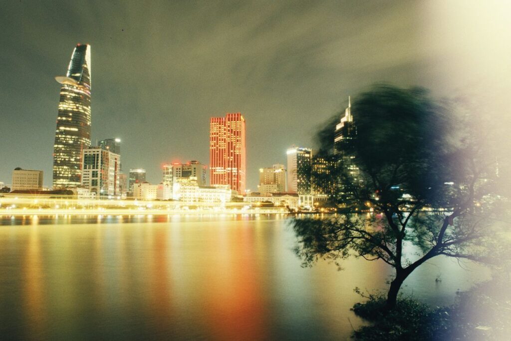 Ho Chi Minh City skyline at night reflected in the Saigon River, Vietnam
