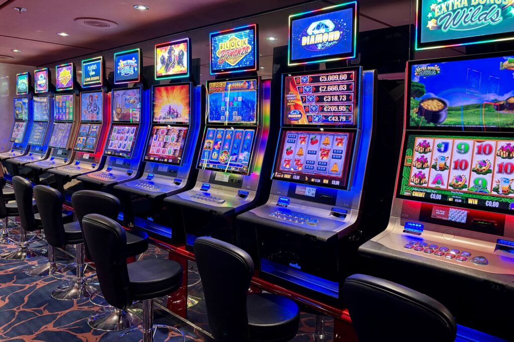 Row of colorful slot machines on a casino floor