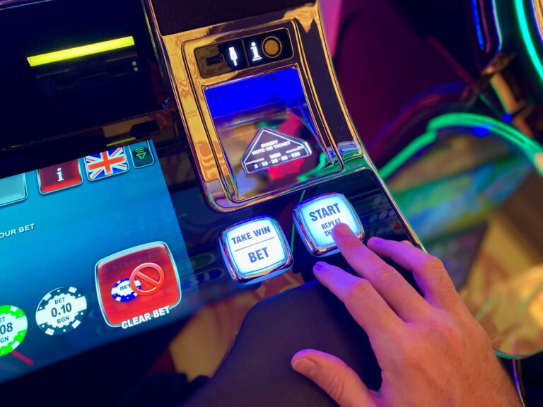 Hand pressing buttons on a slot machine interface