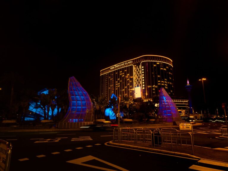 Grand Lisboa casino tower lit up at night in Macau