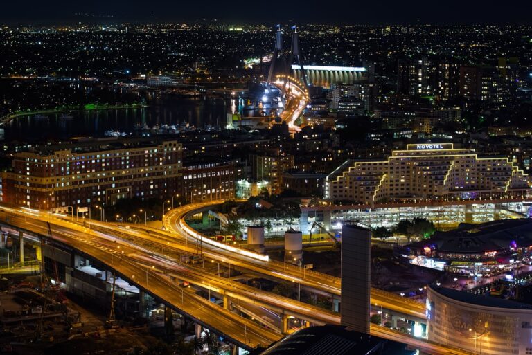 Star accepts A$260M AUSTRAC penalty, flags WhiteHawk facility review event Sydney's Pyrmont and Darling Harbour area lit up at night with the Anzac Bridge behind